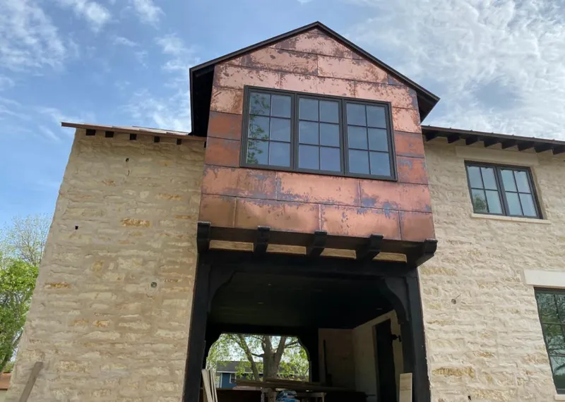 Copper metal panel facade on a stone building for Roof Repair in Zephyrhills